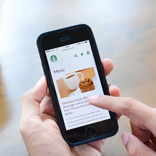 Ordering Starbucks on an iPhone for convenient breakfast.