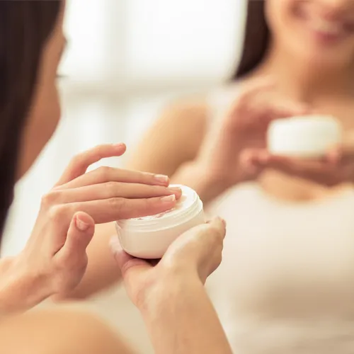 woman using moisturizer