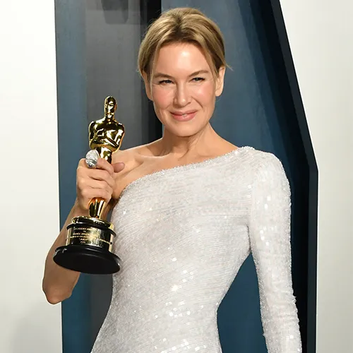 Renee Zellweger smiling on the red carpet.