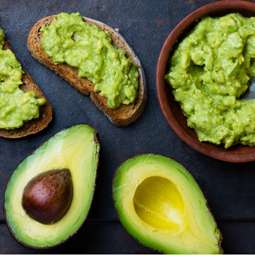 halved avocados side by side with guacamole