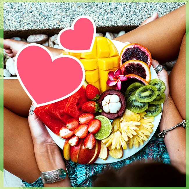 "Plate of healthy tropical fruits including pineapple, mango, and kiwi"