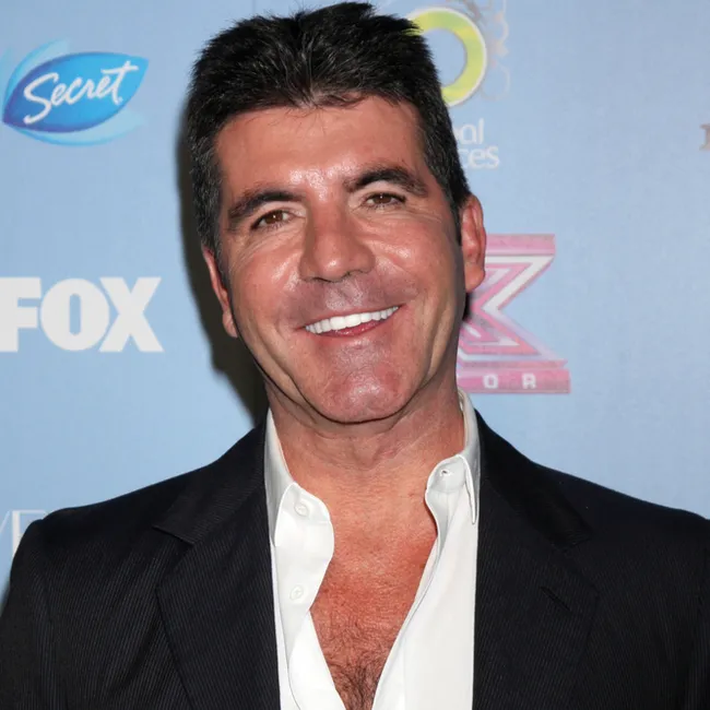 Simon Cowell smiling at a public event
