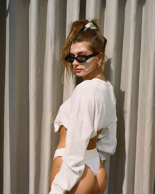 Hailey Bieber flaunting her figure in a stylish outfit.