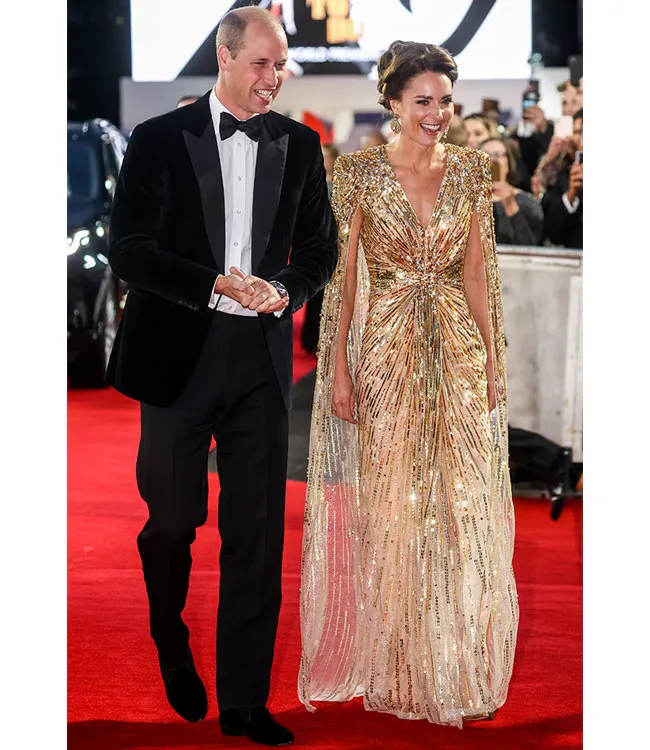 Kate Middleton in a stunning gold dress with Prince William.