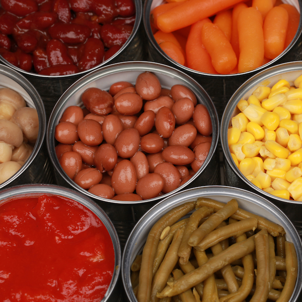 opened cans of various veggies including beans, green beats, corn, tomatoes