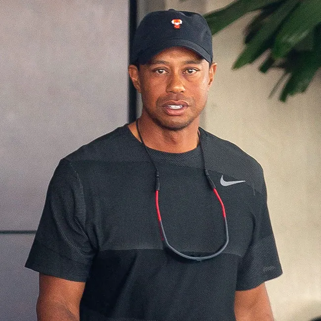 Tiger Woods wearing a Nike shirt during a golf event.