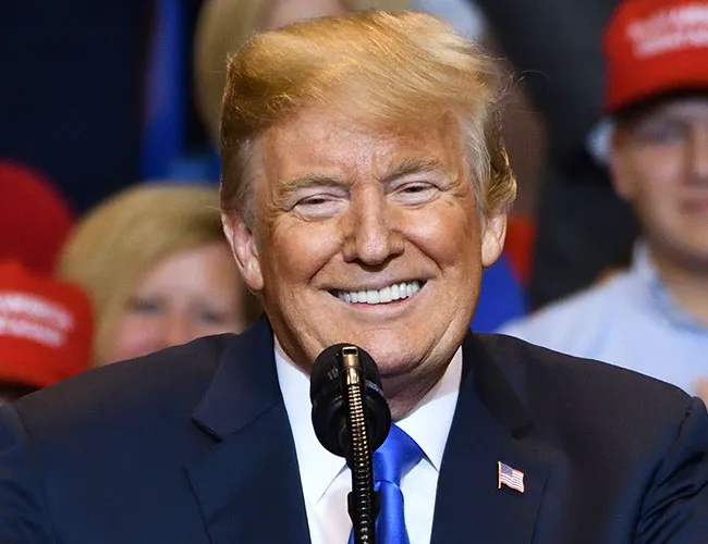 Donald Trump smiling at an event.