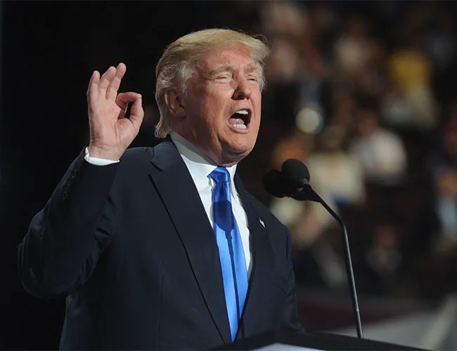 Donald Trump making a gesture during a speech.