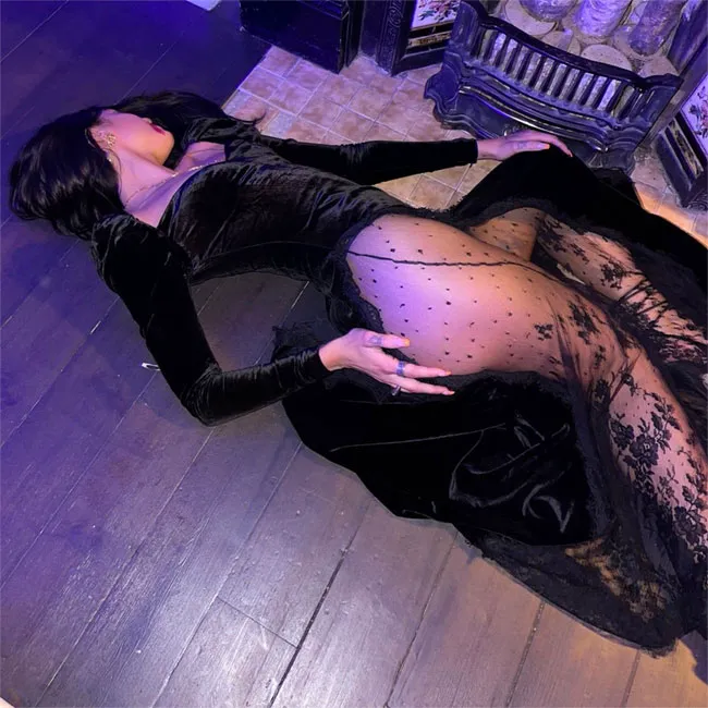 Dua Lipa in sheer Halloween dress at a festive event.