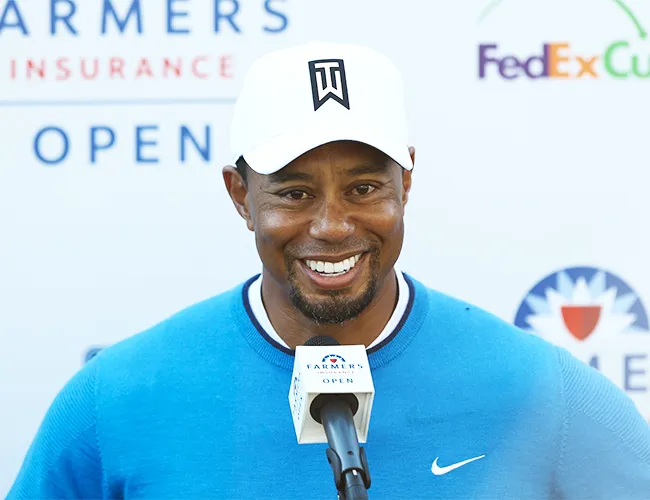 Tiger Woods wearing a blue sweater during an event