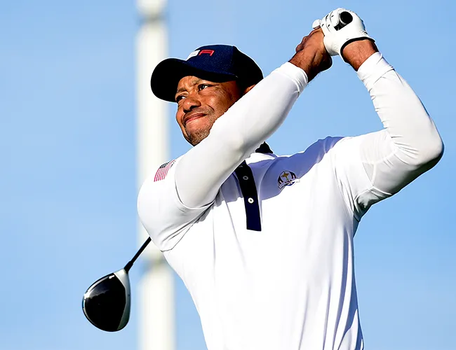 Tiger Woods swinging a golf club on the course