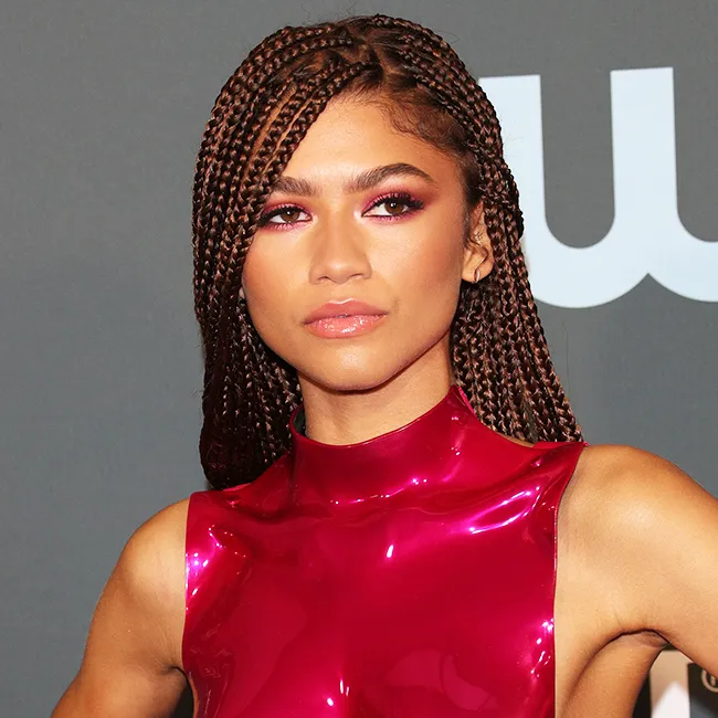 Zendaya smiling in a candid photo.