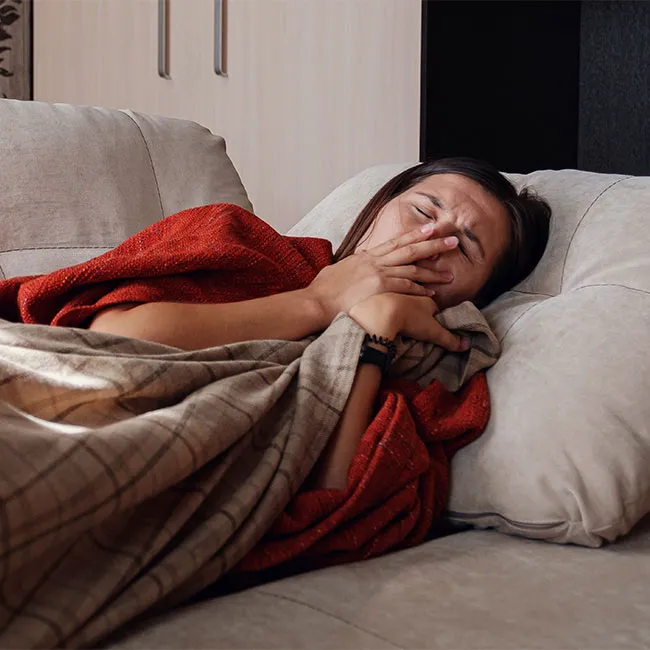 "Sick woman resting on a couch"