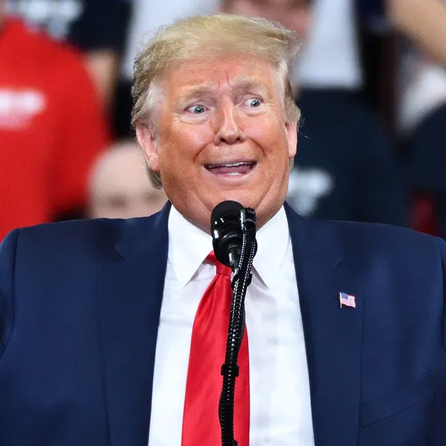 Donald Trump speaking at a rally, engaging with his supporters.