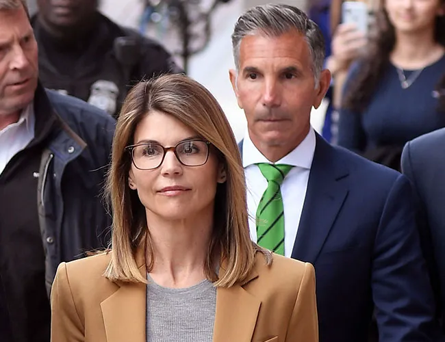 Lori Loughlin and Mossimo Giannulli at a red carpet event.