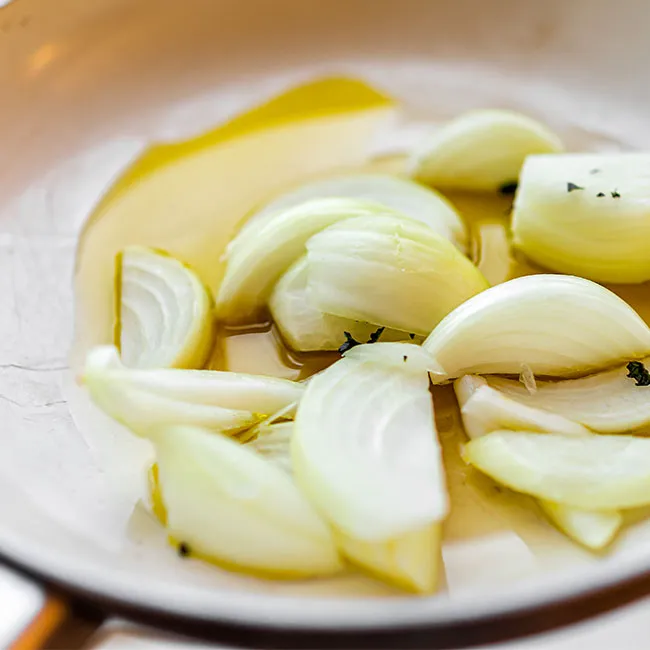 "Pan with onions and oil for cooking"