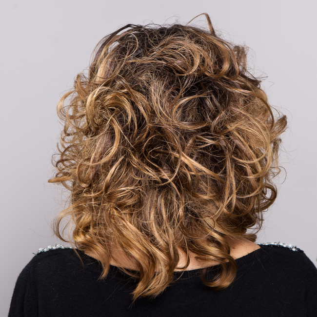 rounded 80s curly haircut auburn hair from the back