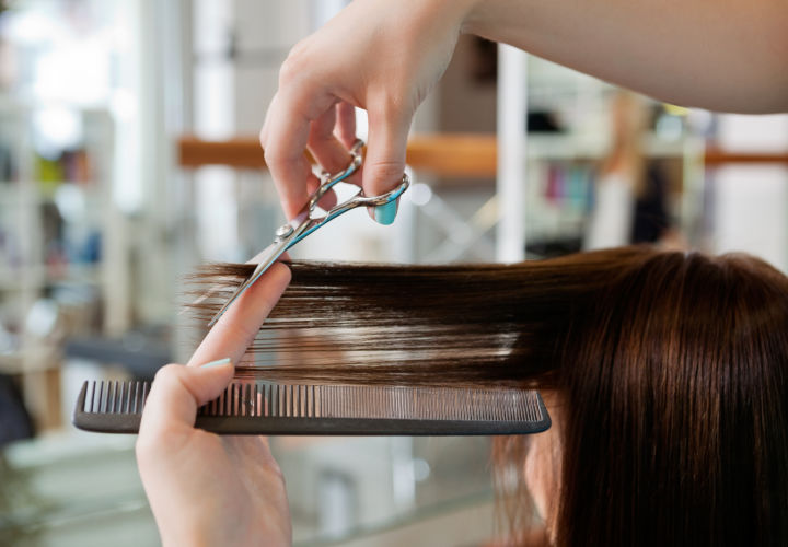 Woman getting a haircut.