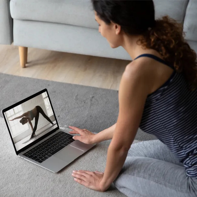 "Woman practicing Pilates at home"
