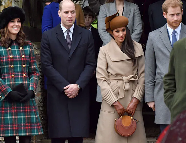 Prince William, Harry, Kate Middleton, and Meghan Markle together at an event.