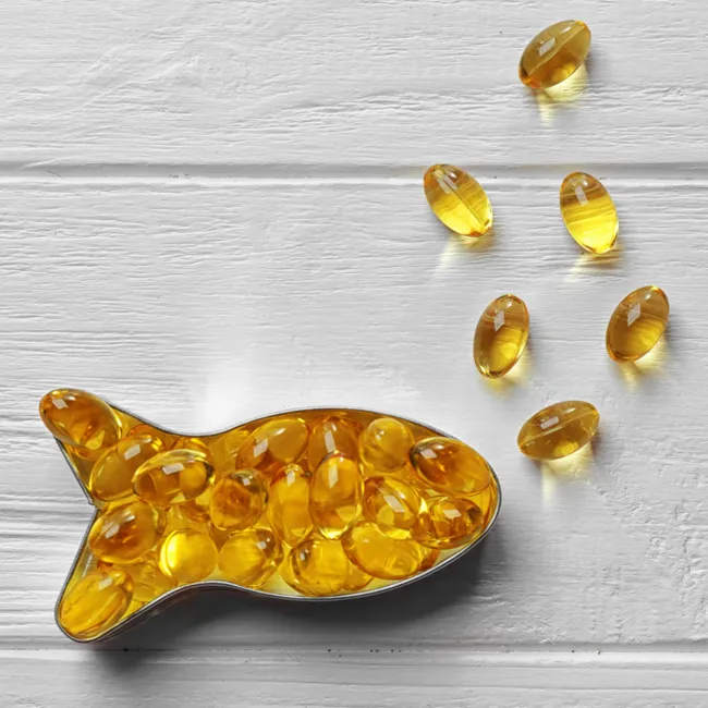 Fish oil supplement capsules with fresh fish illustration.