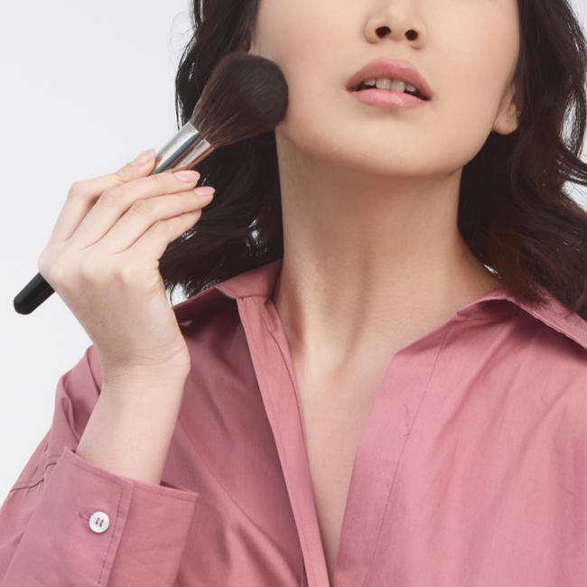 woman using brush on her jawline brushing upwards