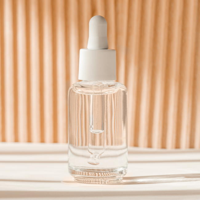 clear bottle orange background serum