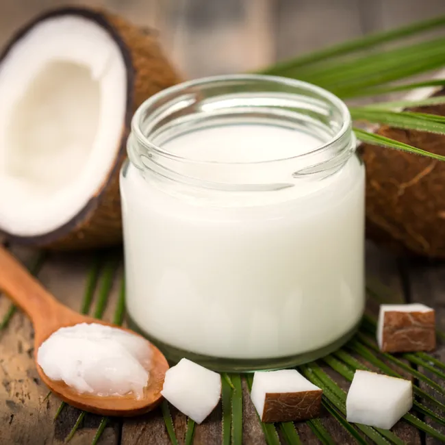 jar of coconut oil beside coconut