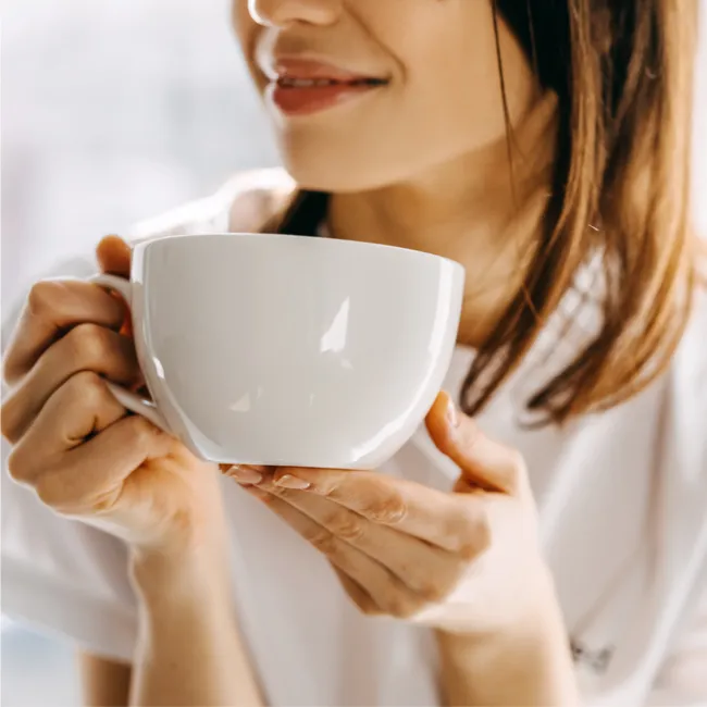 "Person drinking tea from a mug"