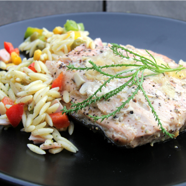greek salmon and orzo on dinner plate