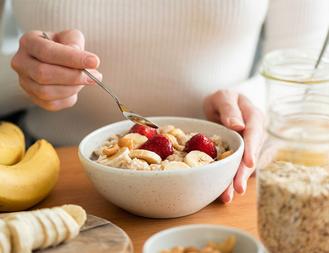 bowl of oatmeal with strawberries and bananas