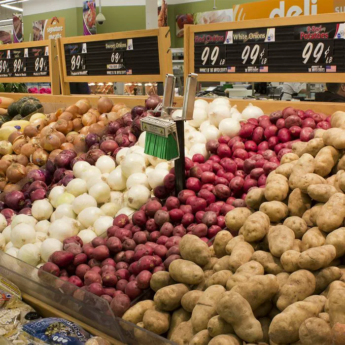 "Onions and potatoes at the grocery store"