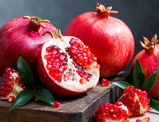 pomegranates on wooden tray