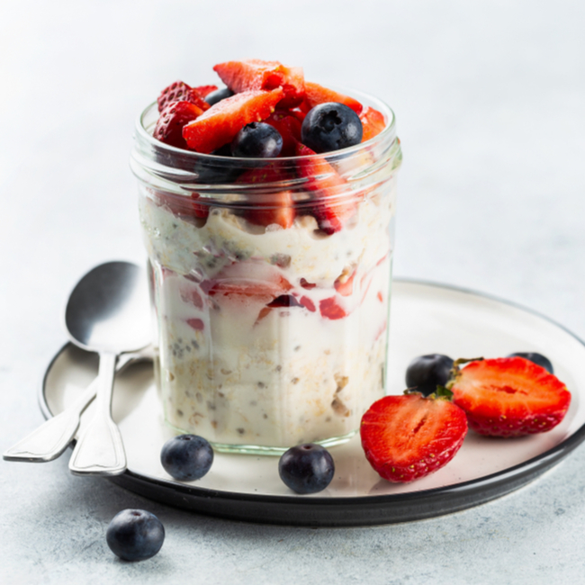 overnight oats with strawberries and blueberries in a mason jar