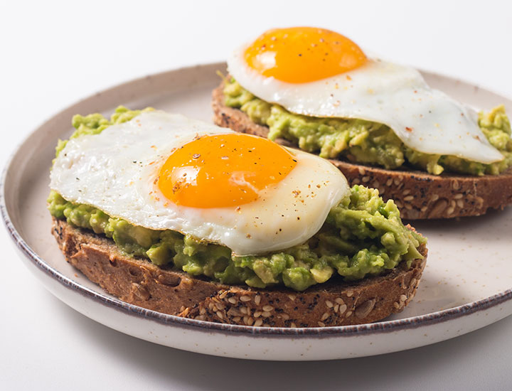 Two avocado toasts with eggs
