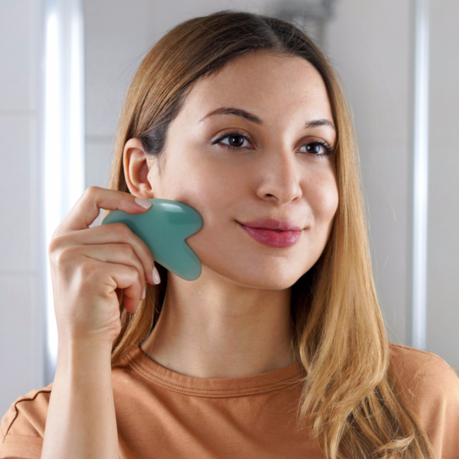 wman sculpting chin with blue gua sha tool