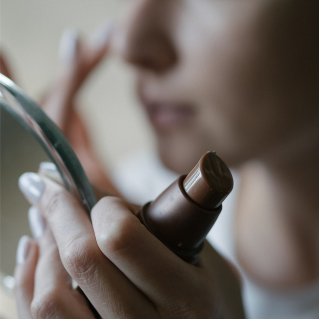 woman adding primer to her skin preparing for concealer