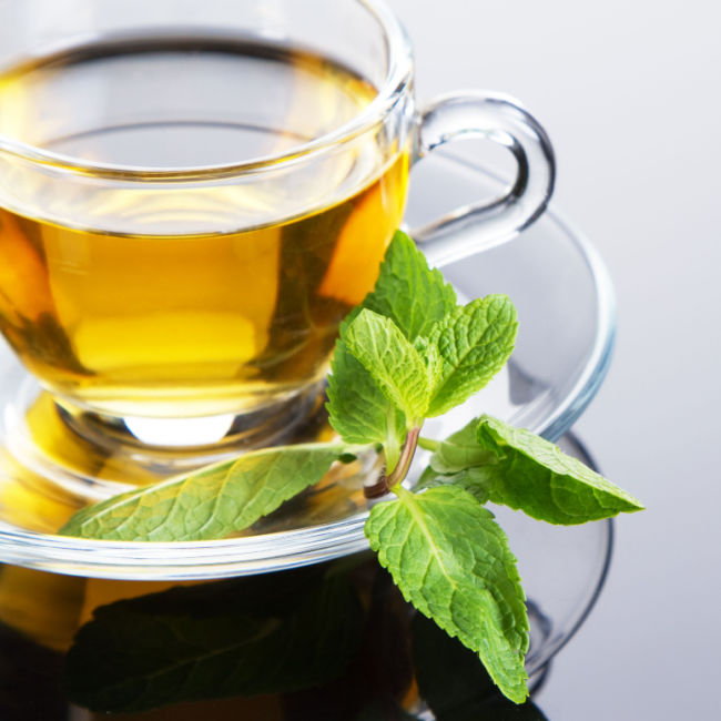 peppermint tea in glass teacup with mint leaves