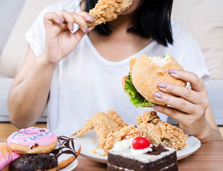 Woman binge eating.