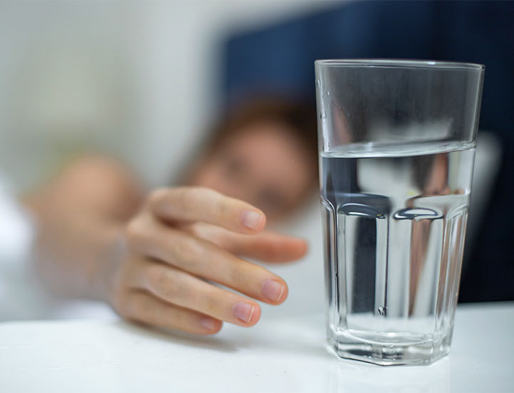 Woman drinking water.