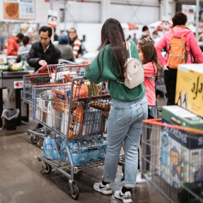 Busy Costco checkout line with shoppers and carts