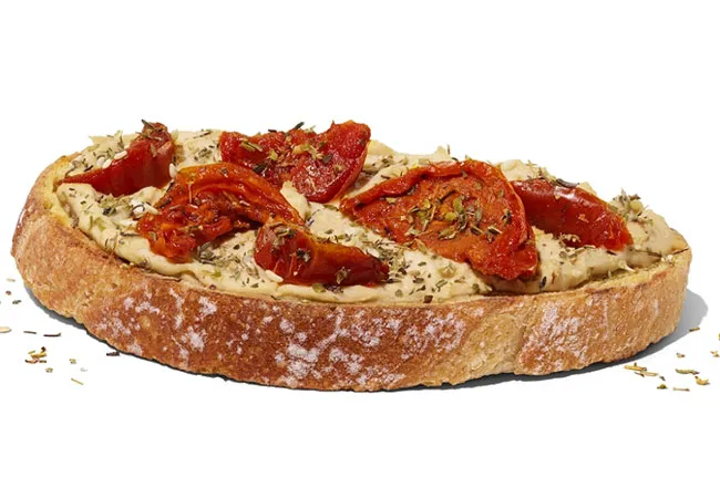 Dunkin' Donuts roasted tomato hummus toast with toppings.