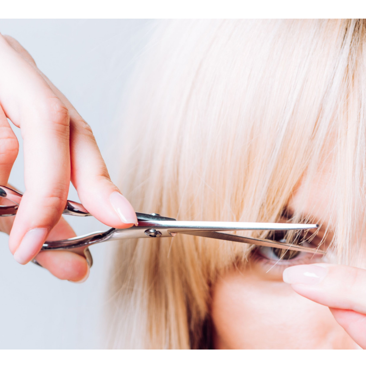 blonde woman metal scissors bang trim haircut salon
