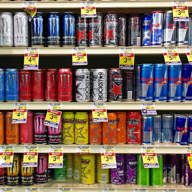 shelves of multicolor energy drinks bottles at the grocery store