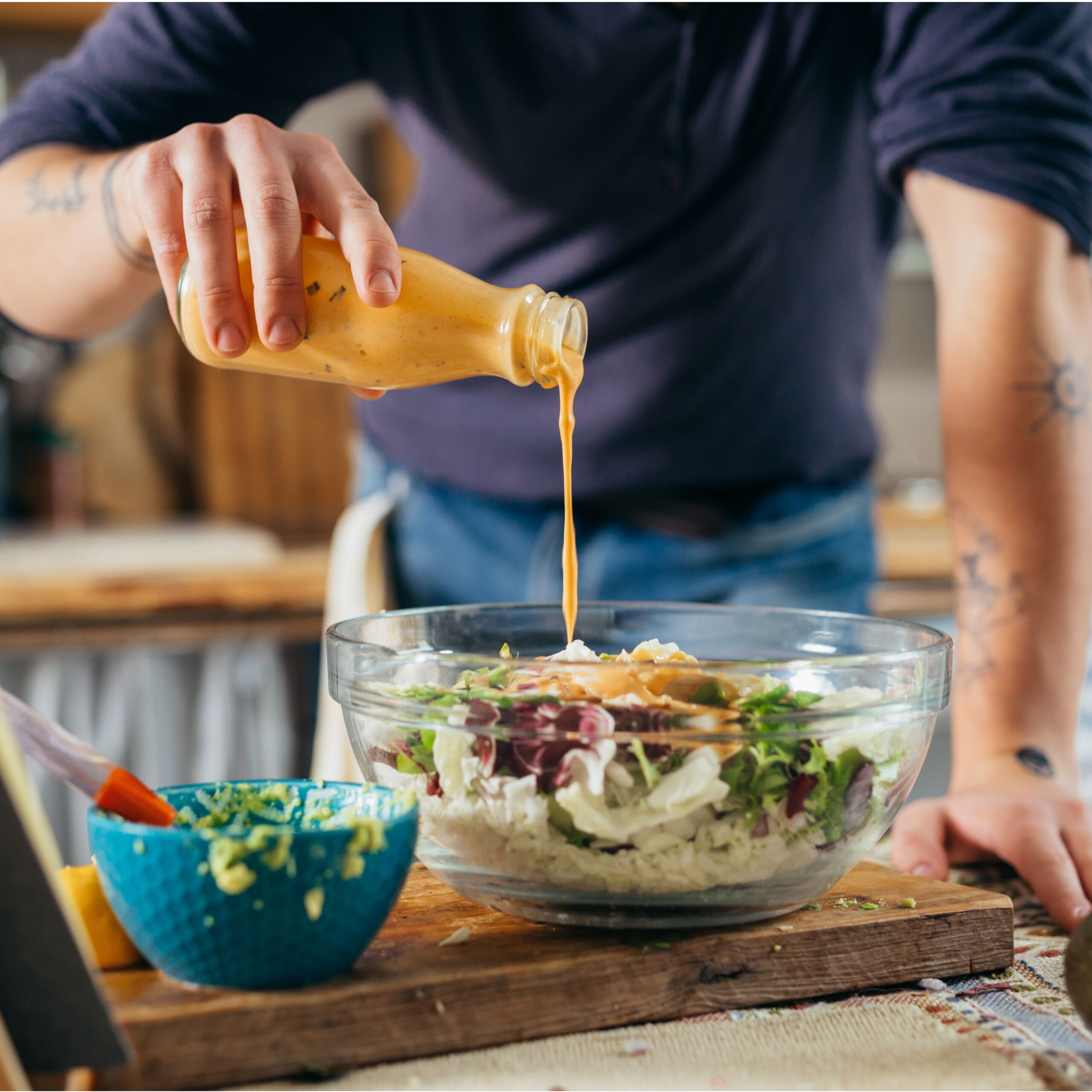 man dressing salad