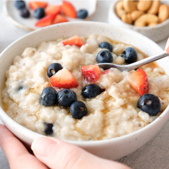 bowl of oatmeal, blueberries, and strawberries