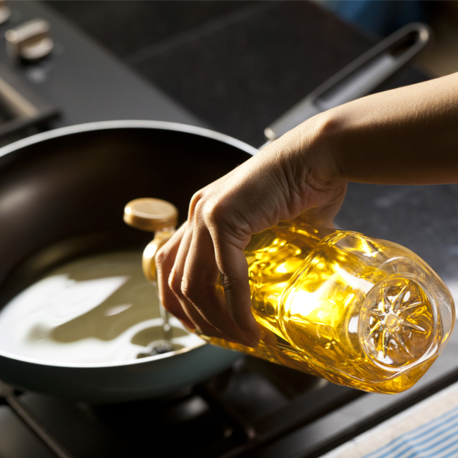 pouring oil into pan