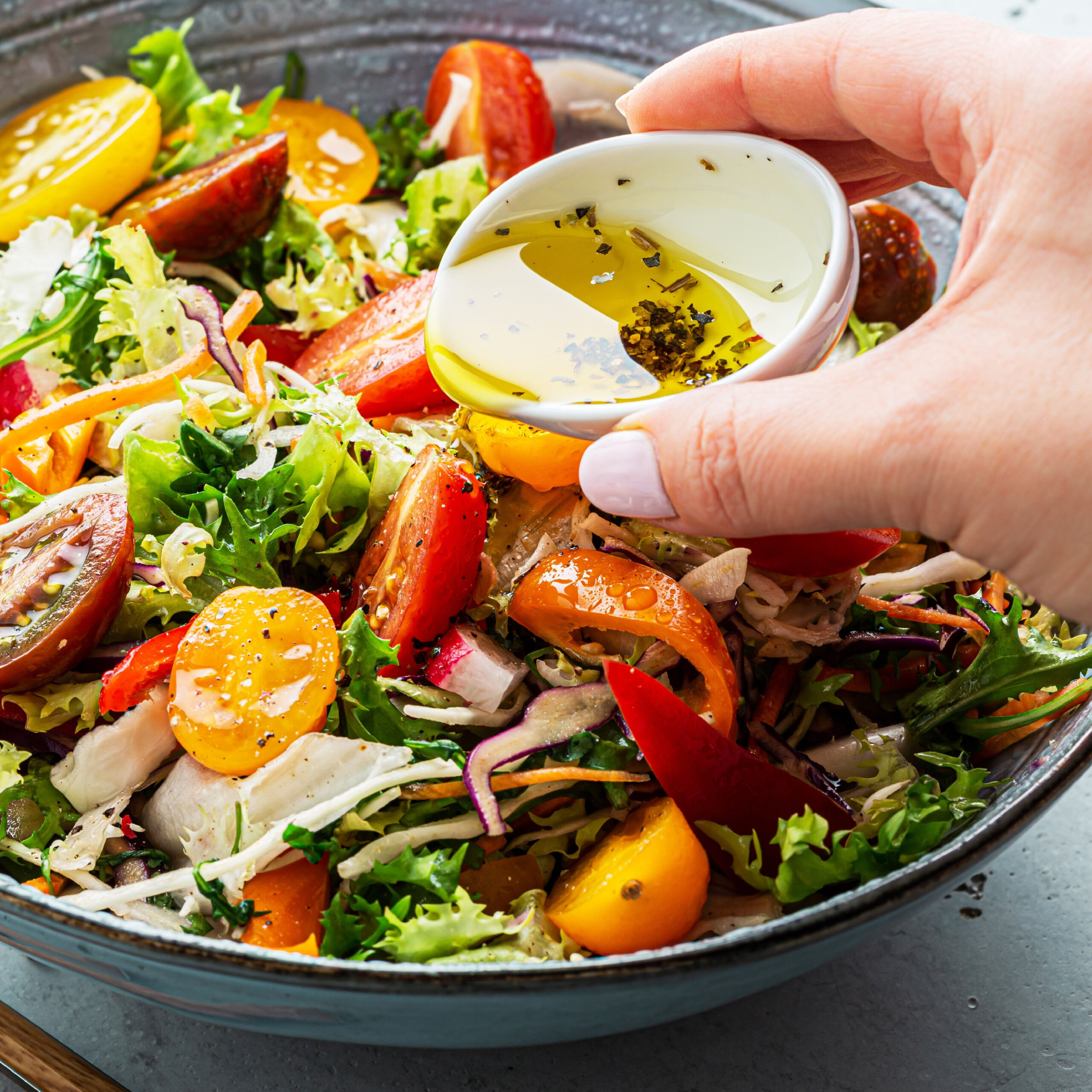 salad dressing pouring on salad