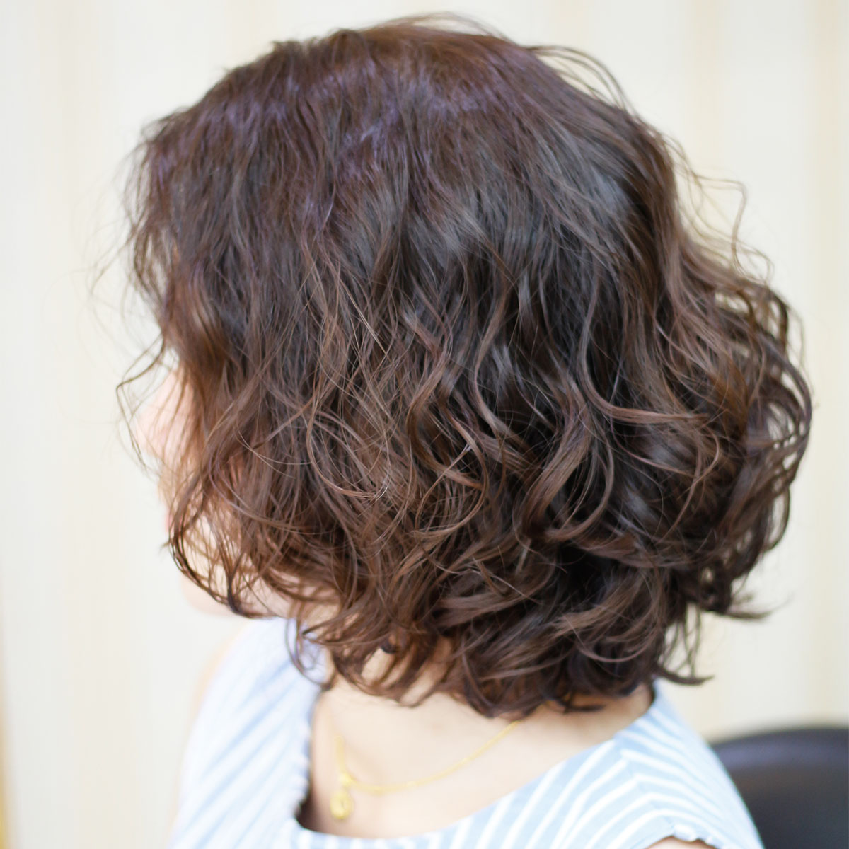 rounded bouncy voluminous brown hair bob from the side salon