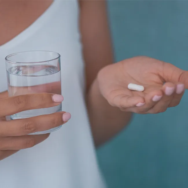 Close-up of a person about to take a pill.